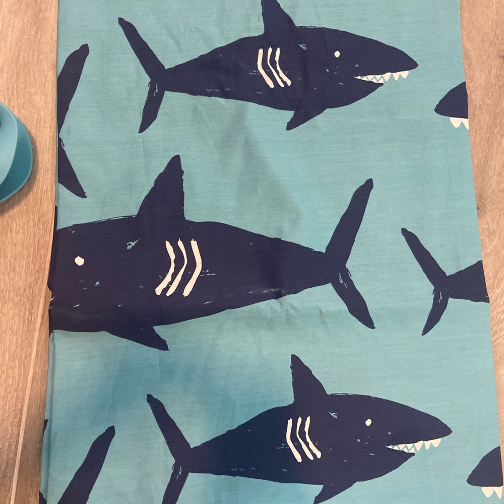 Pillowfort brand shark shower curtain and matching whale faucet cover.